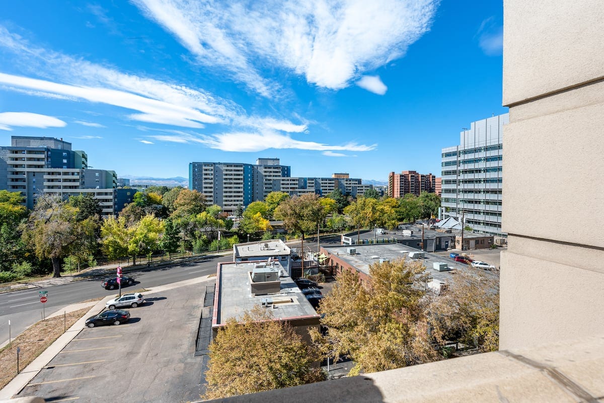 Private balcony view of the downtown Denver skyline to the north and the Rocky Mountains to the west from the Golden Triangle residence.